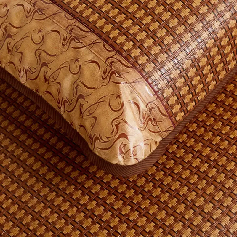 Floral brown woven cooling rattan mat with a decorative glossy beige and maroon edge for bedroom use