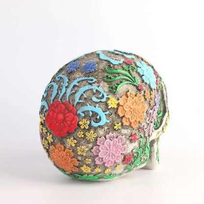A vibrantly decorated gray skull ornament with colorful raised floral patterns for living room decor