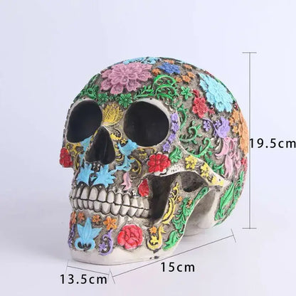 A vibrantly decorated floral colorful skull ornament with intricate pink blue red green and yellow patterns on gray base