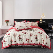 Cream-colored egyptian cotton bedding set with red floral embroidery and satin trim for elegant bedroom decor