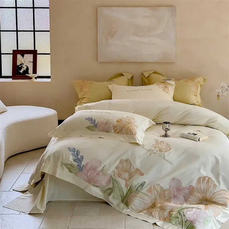 Cream-colored satin bed linens with delicate floral embroidery in soft hues made from decorbites 100s egyptian cotton