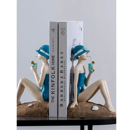Blue resin figure sculpture bookends shaped like vintage beachside women with drinks for living room decor