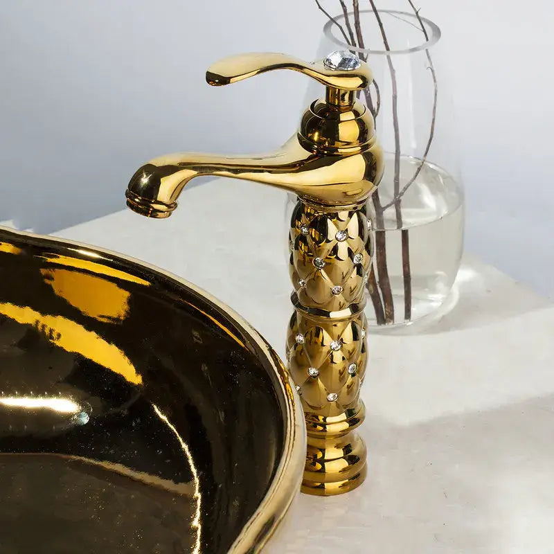 Golden ceramic washbasin with floral embossing and brass mixer faucet featuring a diamond quilted golden finish