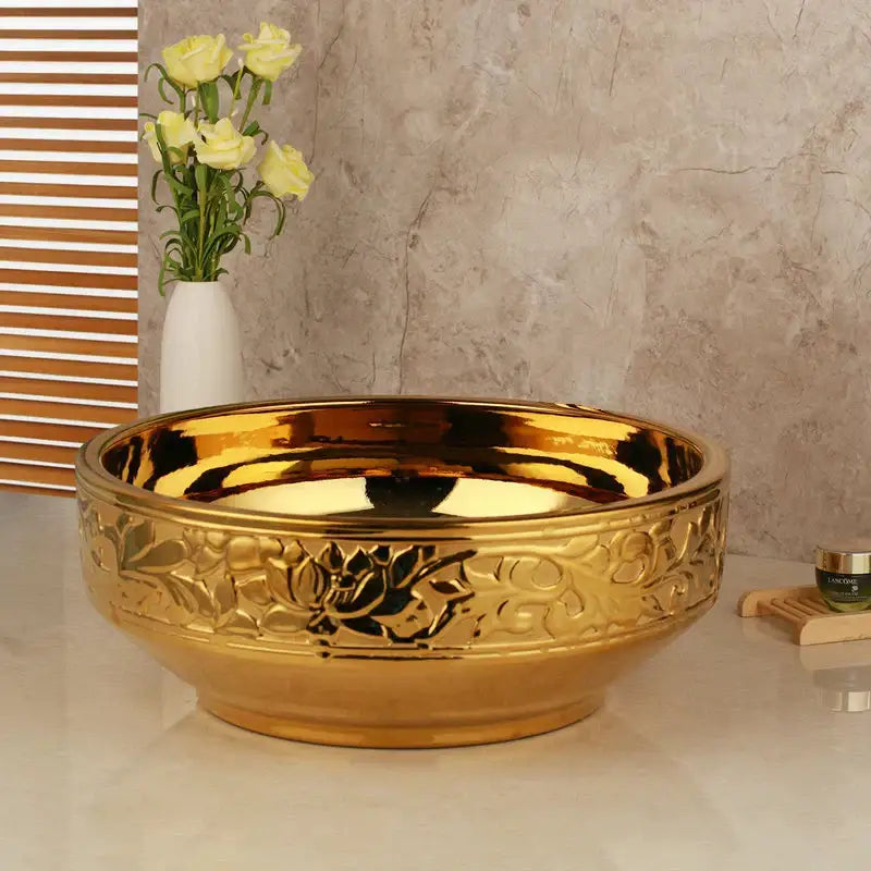 Floral embossed golden ceramic washbasin with intricate design and polished finish paired with brass mixer faucet decorbites set