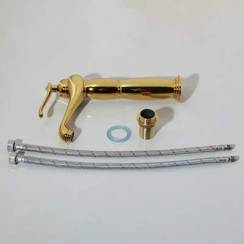 Golden brass mixer faucet with sleek elongated spout and handle in decorbites golden ceramic washbasin bathroom set