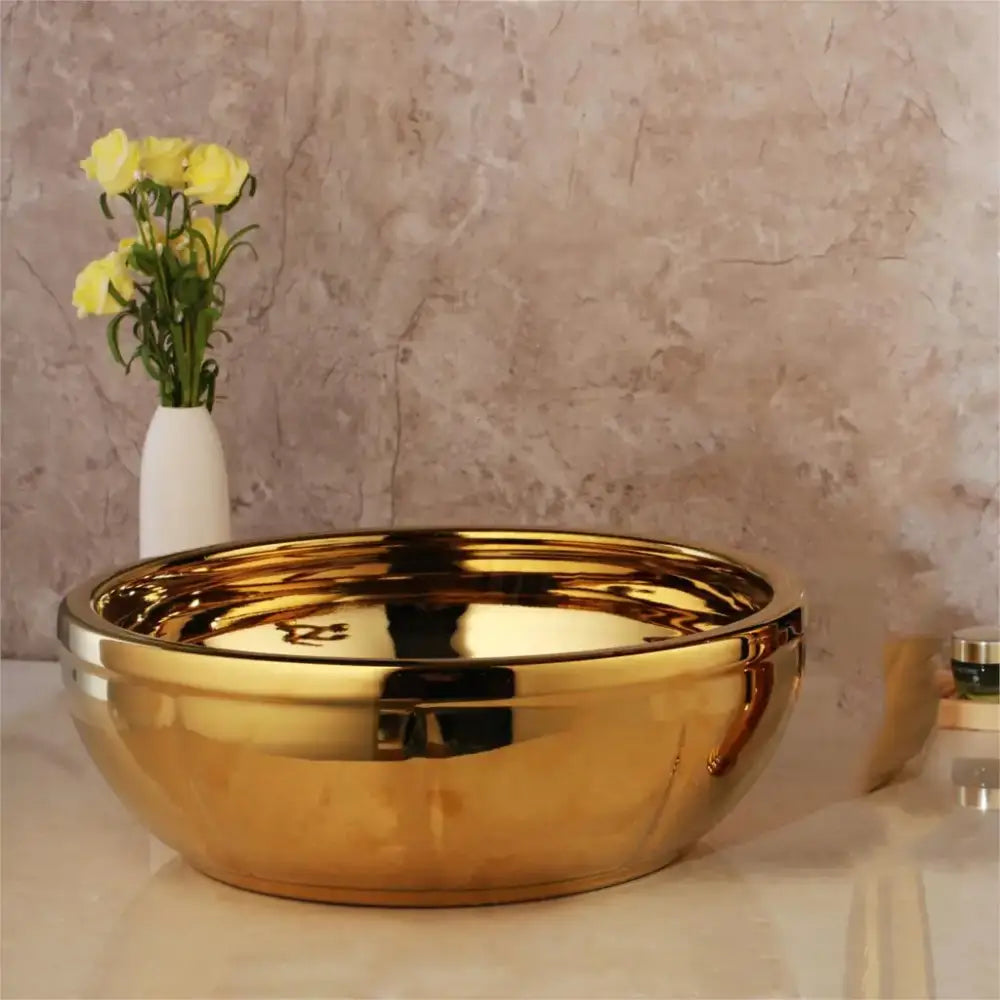 Shiny gold ceramic vessel sink with smooth reflective surface and rounded edges from decorbites golden ceramic set with brass mixer faucet