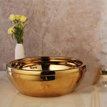 Shiny gold ceramic vessel sink with smooth reflective surface and rounded edges from decorbites golden ceramic set with brass mixer faucet