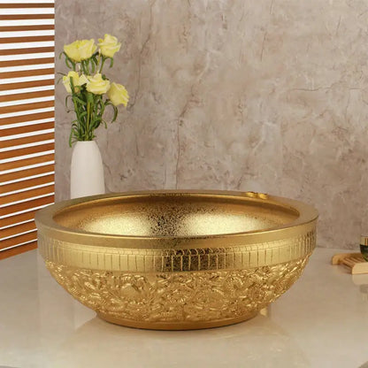 Floral embossed golden ceramic washbasin with intricate detailing paired with a brass mixer faucet bathroom set decorbites golden ceramic