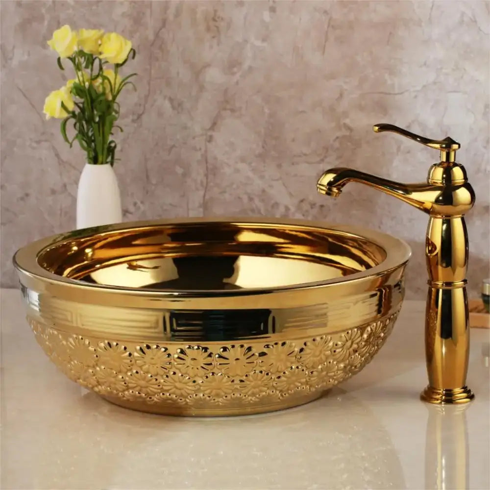 Golden ceramic washbasin with intricate floral embossing and matching brass mixer faucet from decorbites bathroom set