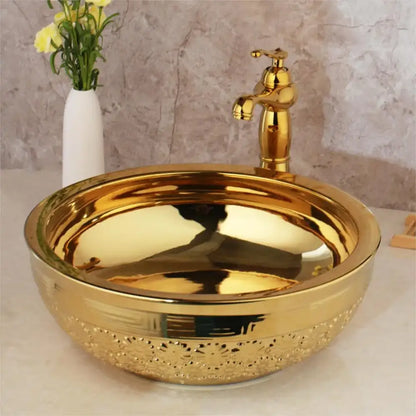 Golden ceramic washbasin with intricate floral embossing and matching brass mixer faucet by decorbites bathroom set