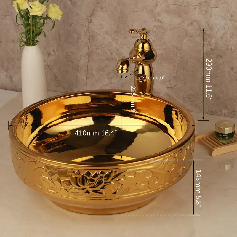 Floral embossed golden ceramic washbasin with intricate design and matching brass mixer faucet for bathroom decorbites set