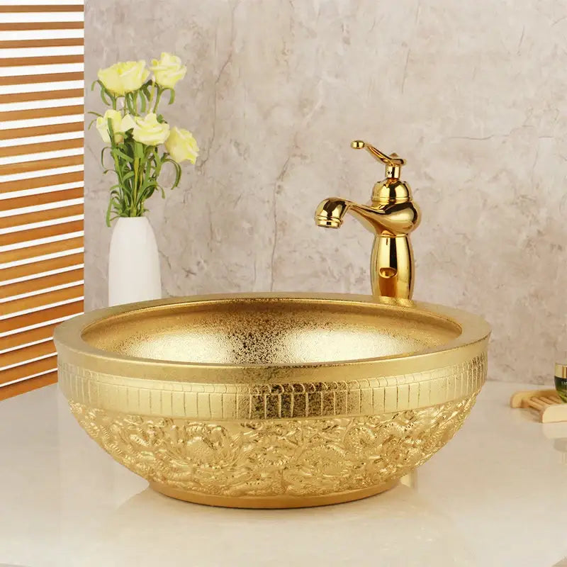 Floral embossed decorbites golden ceramic washbasin with matching brass mixer faucet for elegant bathroom decor