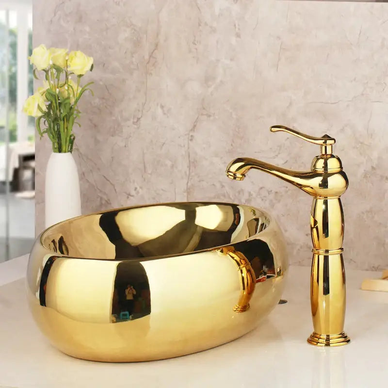 Golden ceramic washbasin with floral embossing and matching brass mixer faucet from decorbites golden ceramic set