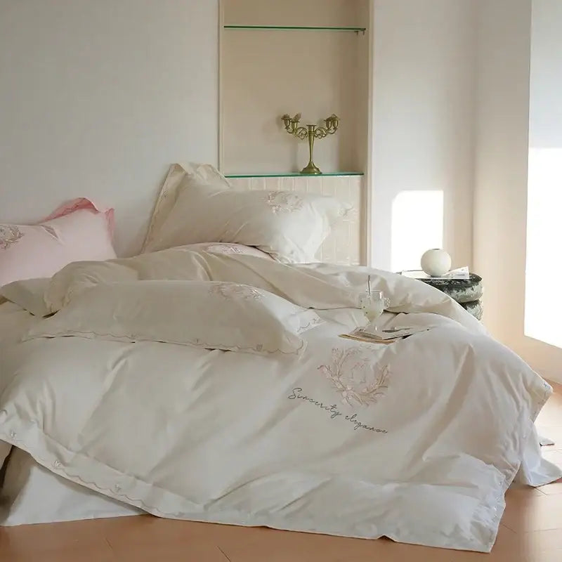 Cream-colored satin duvet cover set with delicate pink floral embroidery and serenity by elegance stitching