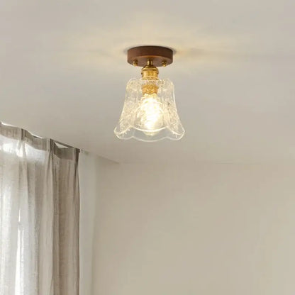 Floral etched glass led ceiling lamp with brass finish and walnut wood mounting plate for living room use