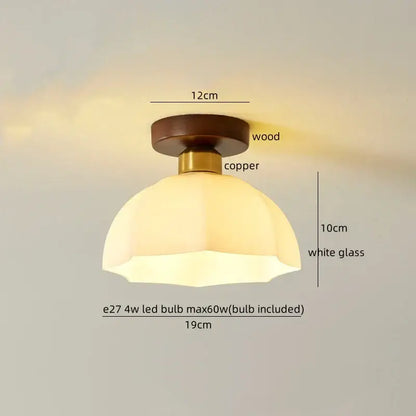 A warm-toned white glass led ceiling lamp with floral etching brass and walnut octagonal fixture for living room