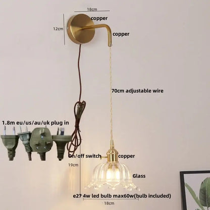 Gold-toned copper led wall sconce with a delicate floral glass lampshade and adjustable wire for bathroom lighting