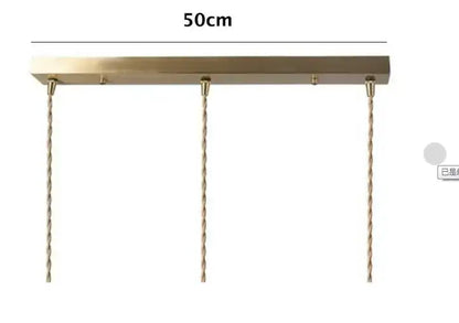 A brass-colored rectangular pendant light fixture with twisted copper chains for floral green glass pendant lights