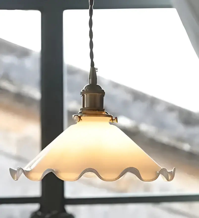 Antique brass-finished glass pendant light with warm frosted scalloped shade for living room lighting