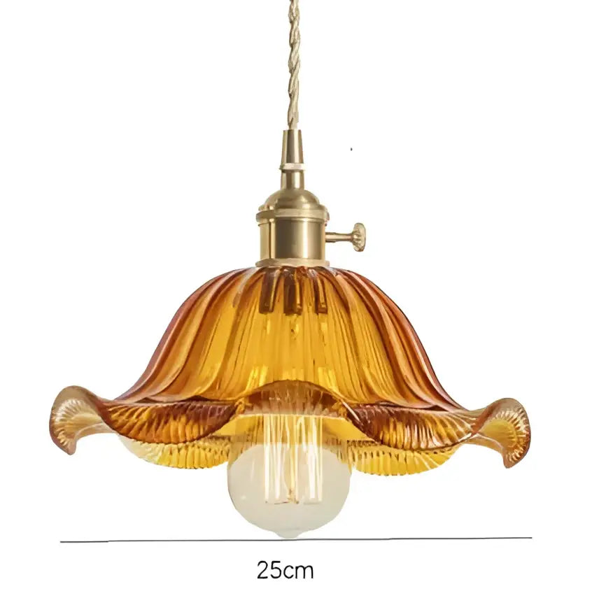 A warm amber glass pendant light with fluted design and golden brass hardware for living room pendant lights