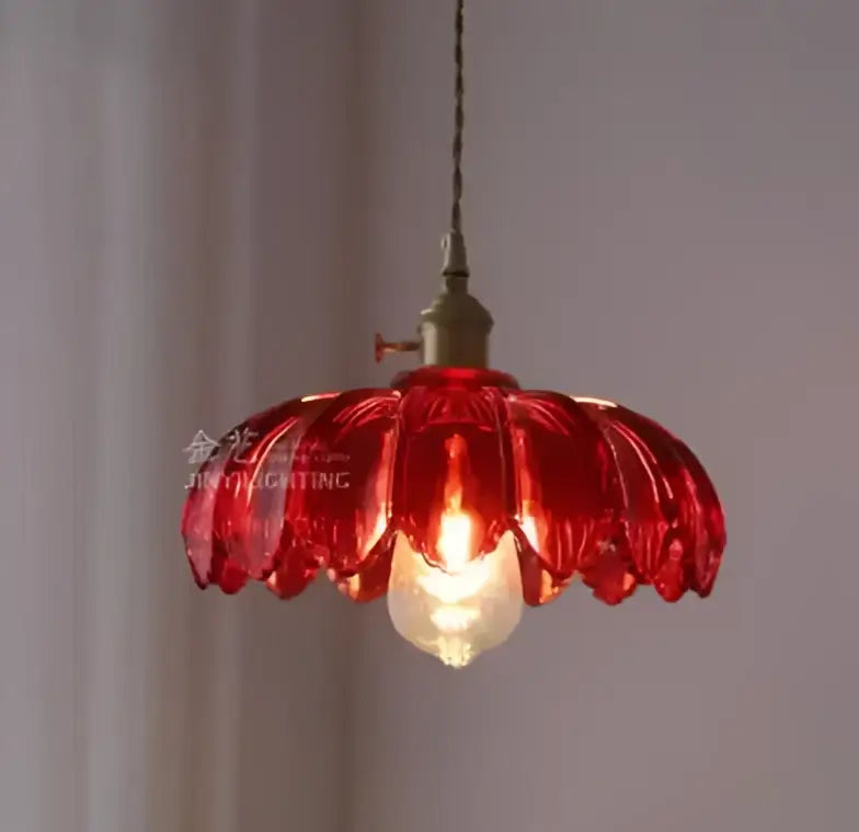 A vibrant red petal-shaped glass pendant light with vintage golden brass fixture ideal for living room pendant lights