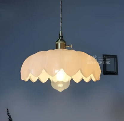 Floral green glass pendant light with soft peach scalloped glass shade and golden brass hardware for living room