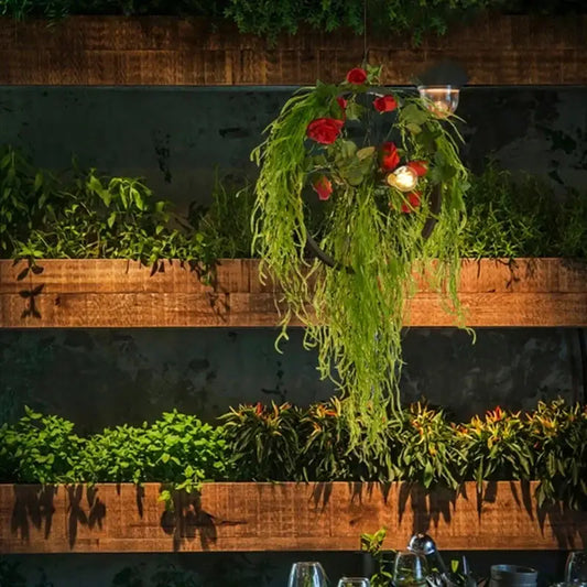 Floral green plant lighting chandelier with cascading greenery and red roses featuring warm decorbites green plant glow