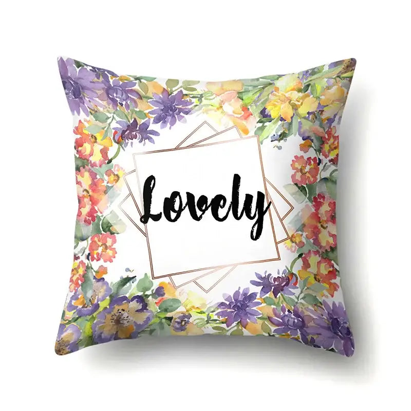 Square pillow cover with vibrant floral design and lovely script in gold frame featuring decorbites green tropical leaves