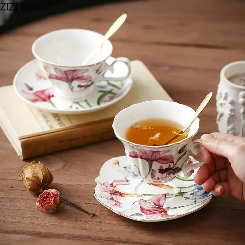 A delicate porcelain teacup with gilded edges and hand-painted pink and purple floral decorbites iris pattern mug set