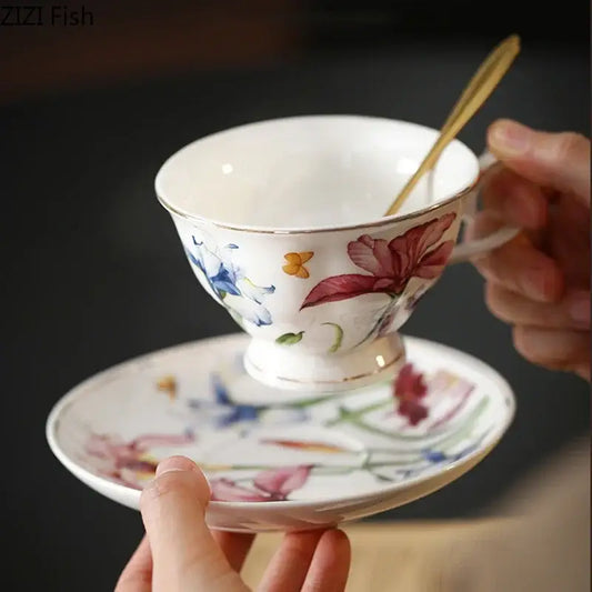 A delicate white porcelain mug set with decorbites iris pattern floral design and gilded gold rim for dining room use