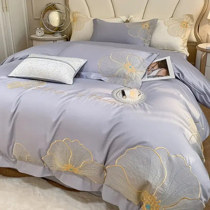 Lavender satin duvet cover set with gold-threaded floral embroidery and matching pillowcases in embroidered egyptian cotton bedding set
