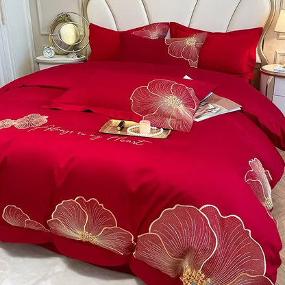 Red satin duvet cover with embroidered gold floral patterns and always in my heart stitching in an embroidered egyptian cotton bedding set