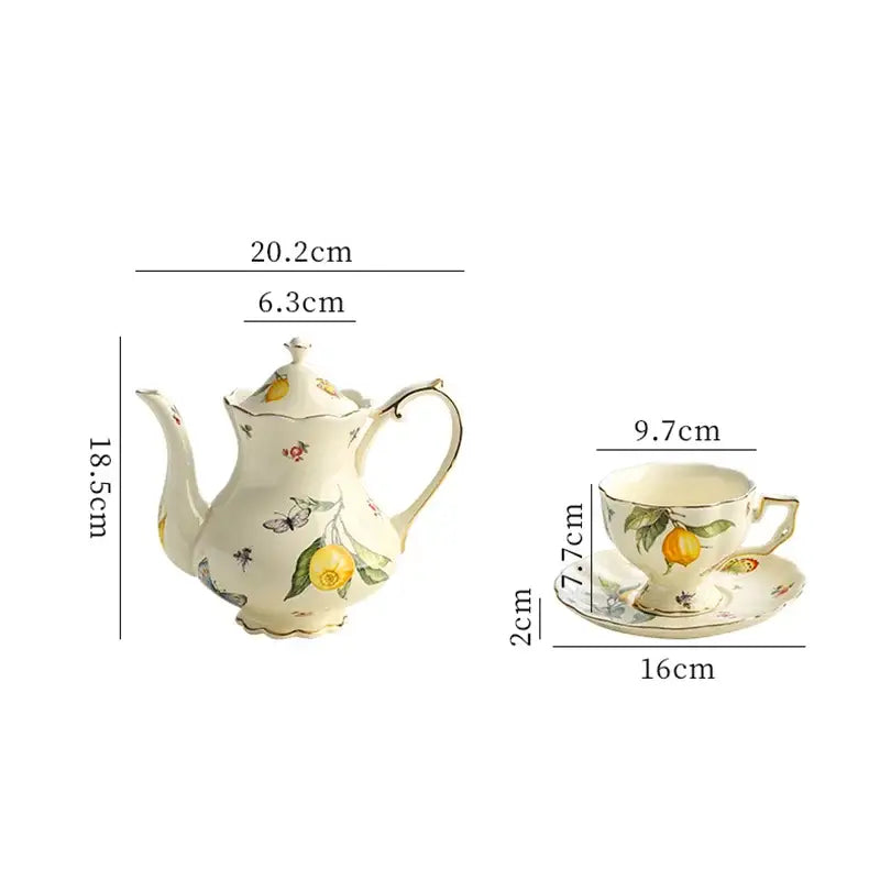 Cream-colored porcelain tea set with delicate yellow lemon and butterfly motifs gold trimmed for dining room use