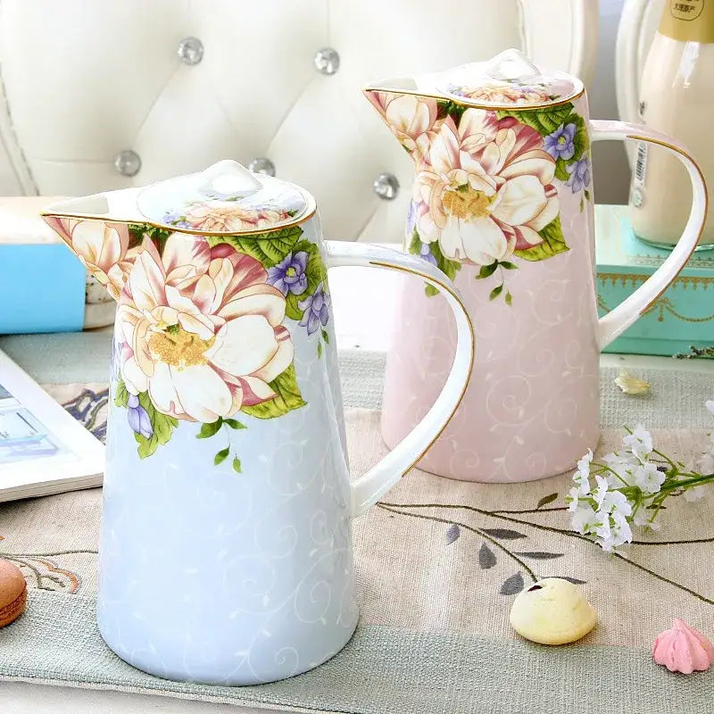 A delicate pastel blue porcelain pitcher with pink white and purple floral patterns from decorbites bone tea set