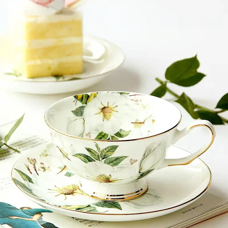 A delicate white porcelain teacup and saucer with floral patterns and gold trim from decorbites bone bone tea set