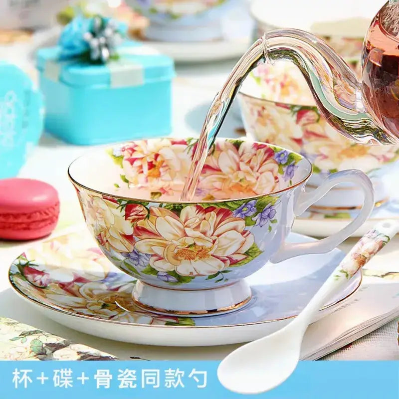 A delicate porcelain teacup with vibrant pink yellow and purple floral pattern and gold trim from decorbites bone china tea set