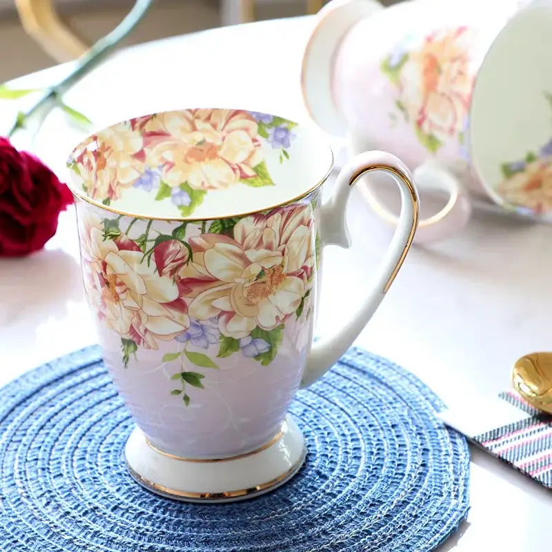 A delicate lavender floral light blue bone china tea set mug with intricate peach cream purple patterns and gold accents by decorbites bone