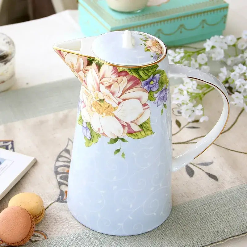 A light blue ceramic tea set pitcher with vibrant floral pattern and gold trim by decorbites bone china