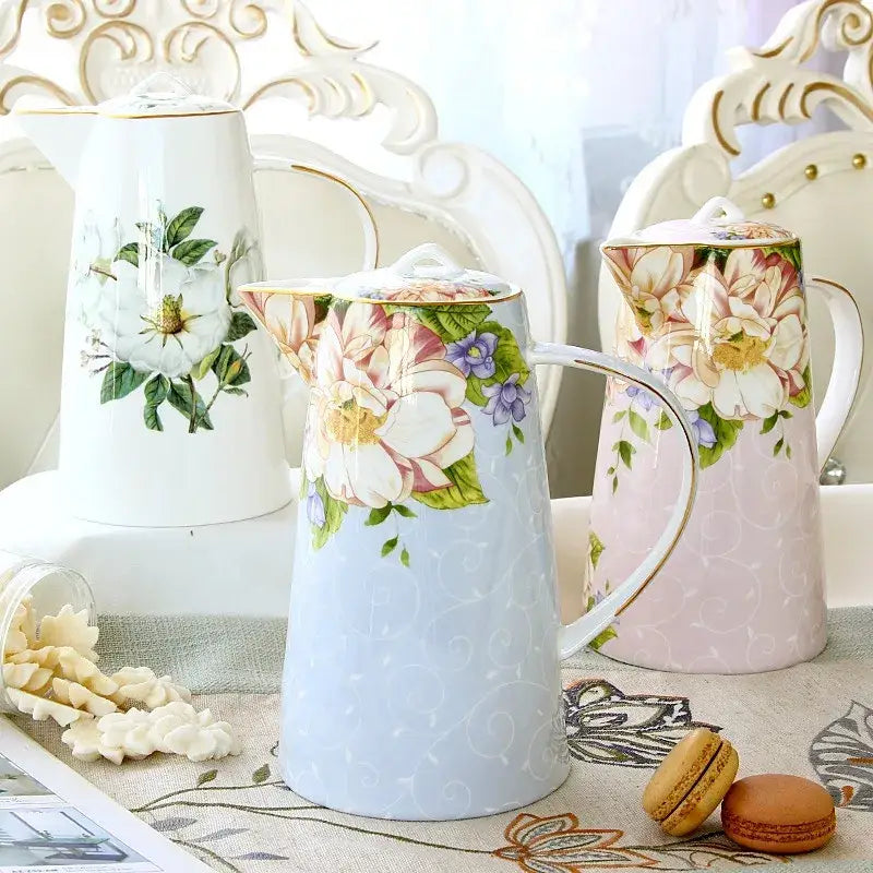 A delicate light blue bone china tea set pitcher with hand painted floral design and gold trim by decorbites bone