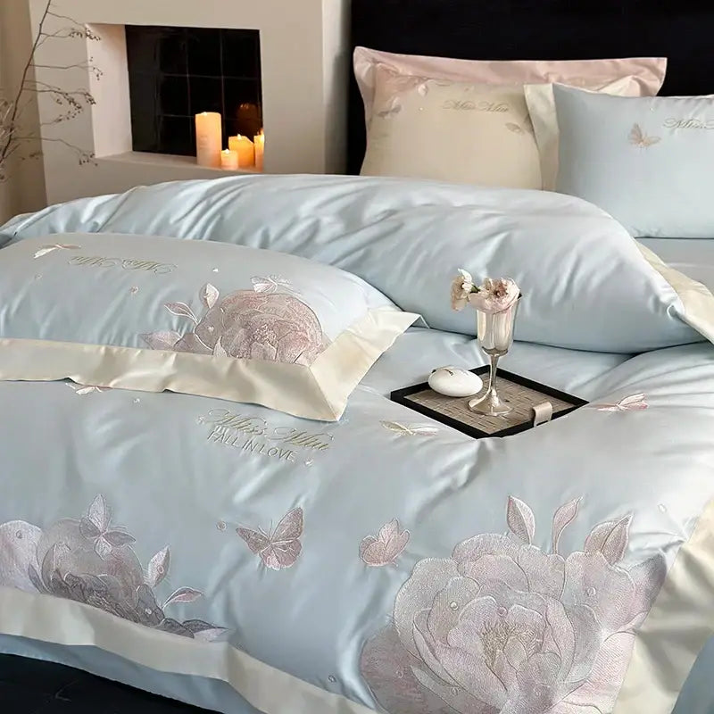 Light blue satin bedding set with intricate pink and silver floral embroidery made from decorbites 1000tc egyptian cotton