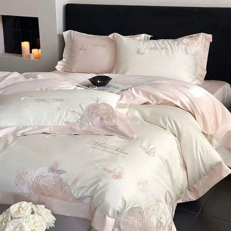 Pink satin bedding set with delicate floral and butterfly embroidery in pastel tones made from decorbites 1000tc egyptian cotton