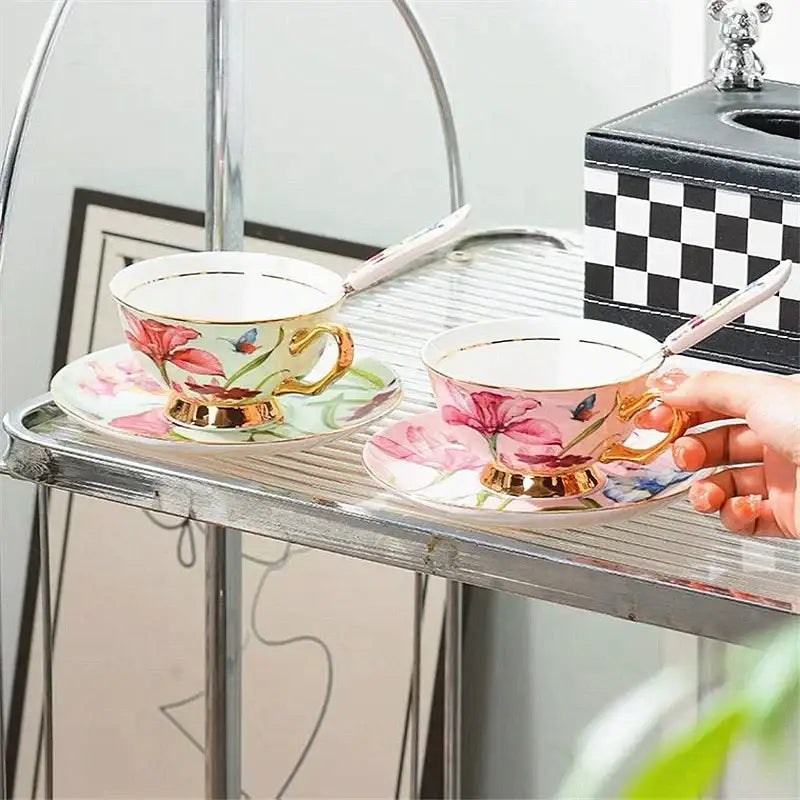 A delicate porcelain lily flower tea set with pink floral and butterfly designs and gold trim for elegant dining