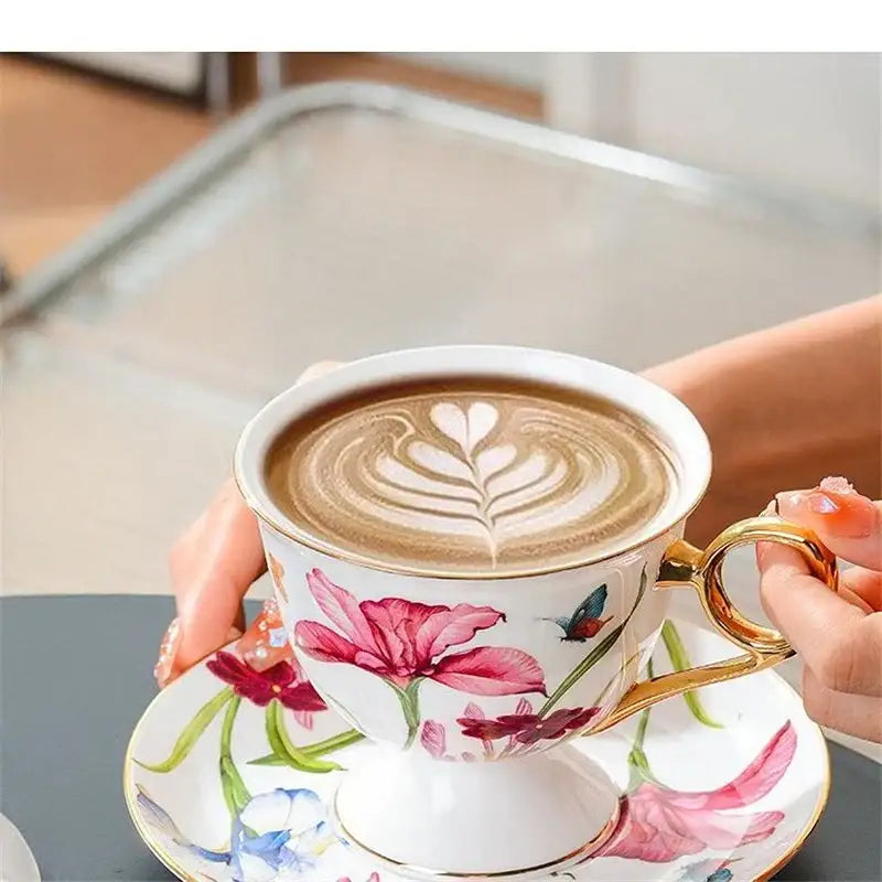 A delicate white porcelain lily flower tea set with gold rim featuring pink floral and bird motifs for dining room use