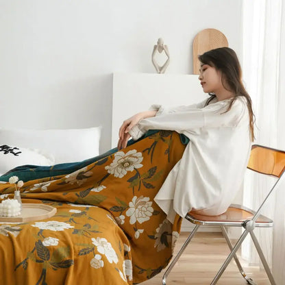 Warm mustard cotton throw blanket with delicate white floral pattern draped elegantly for bedroom decorbites cotton throw