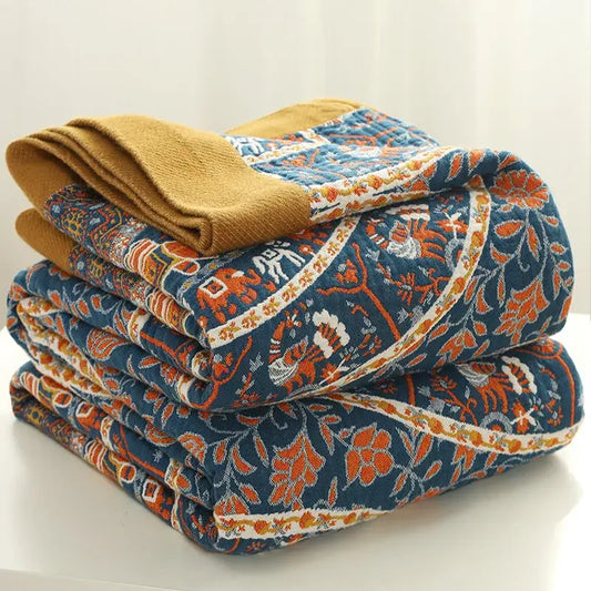 Stacked quilted pants in navy blue with vibrant orange white floral patterns and mustard yellow cuff for decorbites cotton picnic blanket bedspread