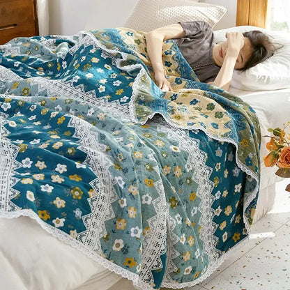 A soft teal and cream floral sofa cover with delicate white lace trim made of decorbites breathable cotton gauze
