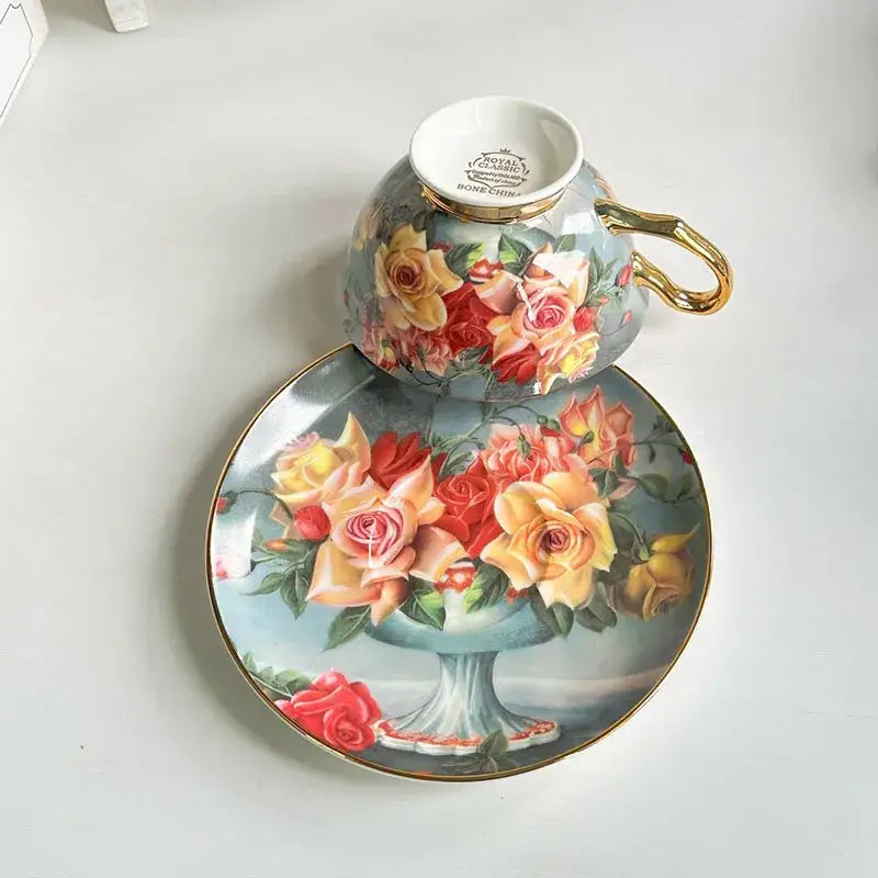A delicate bone china coffee cup and saucer set with decorbites flowers pattern in pink yellow and red roses