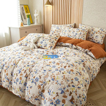Cream-colored soft cotton bedding set with embroidered bunny and flower print in blue brown and yellow tones