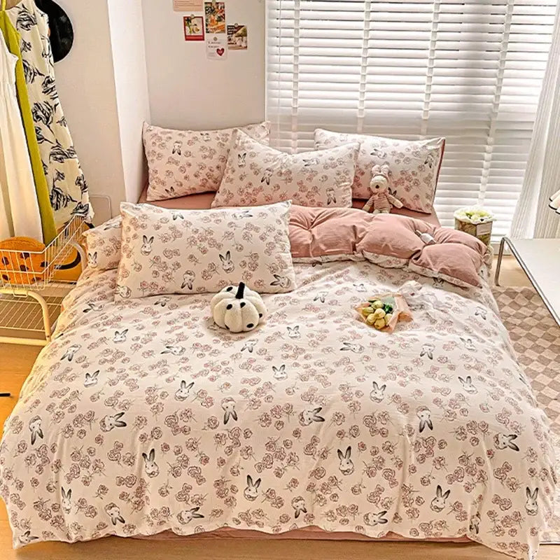Cream-colored comforter set featuring cotton flower printed rabbits in black and muted pink for decorbites bedding