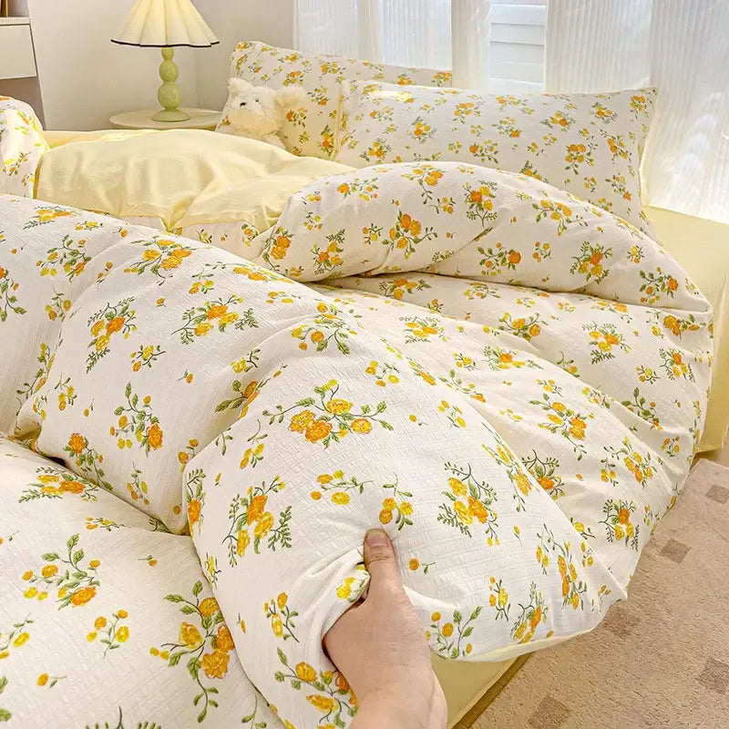 A soft off-white comforter set with delicate yellow and green floral pattern decorbites cotton flower printed bedding